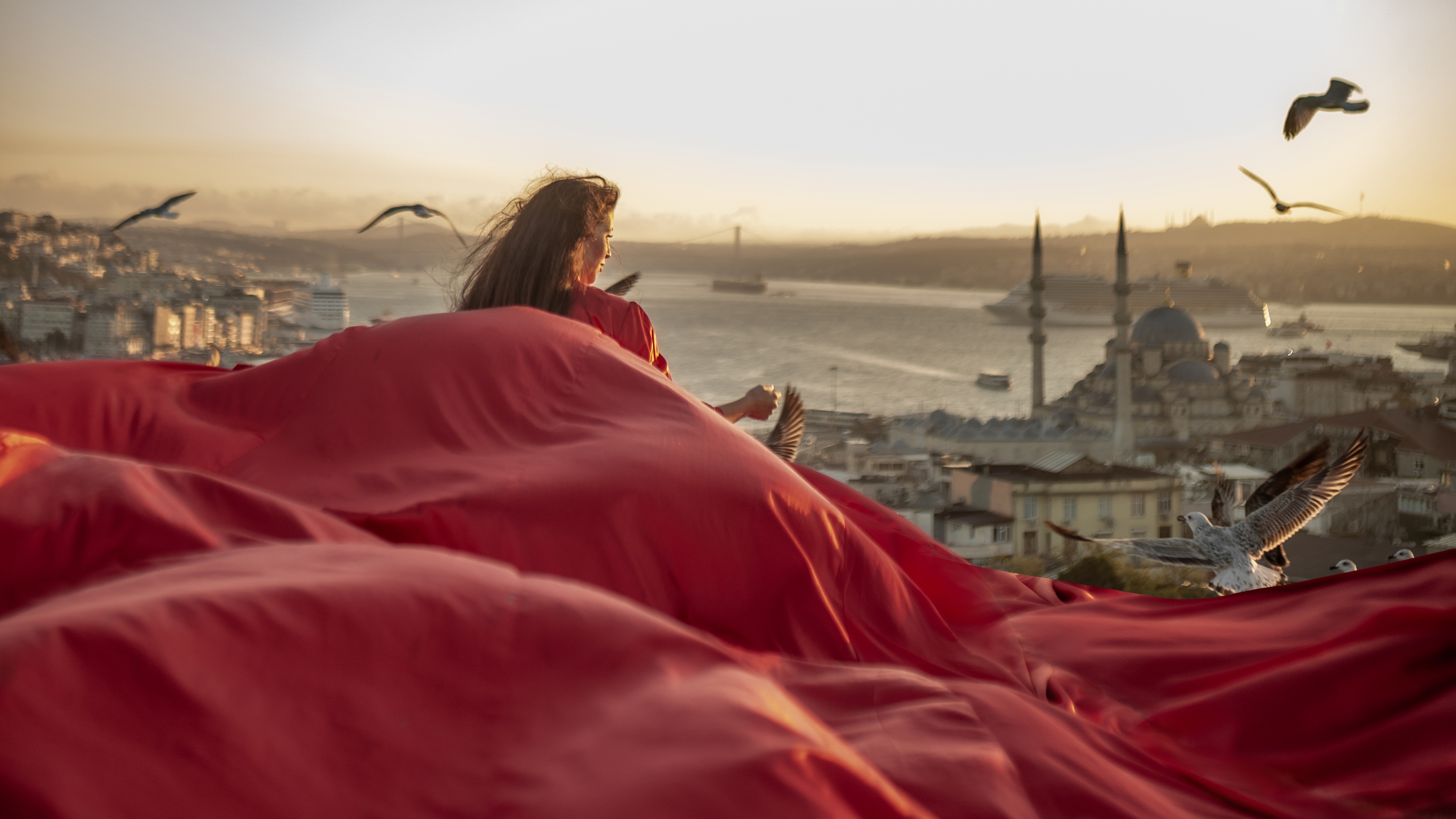 Red flying dress rooftop photoshoot in Istanbul with panoramic skyline view