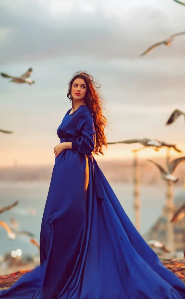 Luxury rooftop photoshoot in Istanbul at sunrise with elegant blue dress