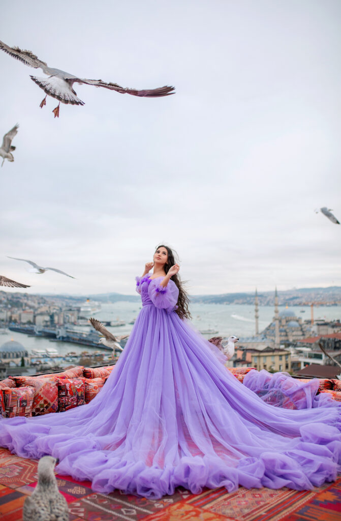 Rooftop photoshoot in Istanbul with panoramic skyline and a flowing purple dress
